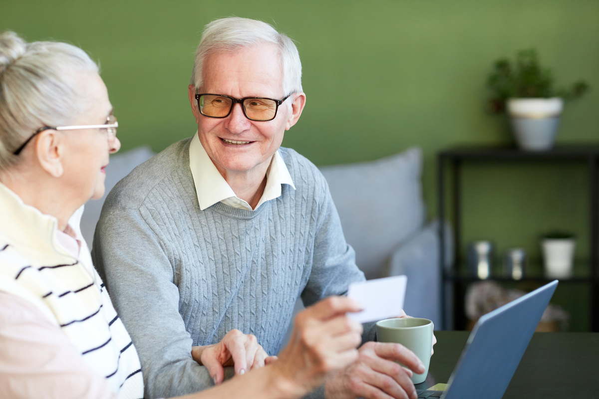 Happy senior man shopping online